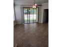 Bright living room featuring tile floors, a ceiling fan, and a large sliding glass door to the patio at 5473 Sunset Falls Dr, Apollo Beach, FL 33572