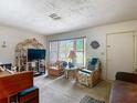 Cozy living room with a large window providing natural light and neutral carpeting at 6832 Treehaven Dr, Spring Hill, FL 34606