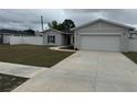 Beautiful home featuring a well-maintained lawn and a spacious driveway at 9397 Northcliffe Blvd, Spring Hill, FL 34606