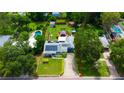 An aerial shot showcases the home's layout, with a long drive, pool and deck, solar and expansive backyard at 101 N Corona Ave, Clearwater, FL 33765