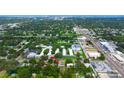 A distant aerial view shows the home nestled in a wooded area with mature trees and city view at 101 N Corona Ave, Clearwater, FL 33765