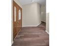 Spacious foyer featuring hardwood floors and a solid wood door with decorative glass inserts at 11279 Oakridge Trl, Seminole, FL 33772