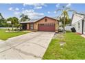 Delightful single-story home with a well-manicured lawn, complemented by graceful palm trees, creating a serene setting at 11304 Plumtree Ct, Riverview, FL 33579