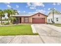 Inviting single-story home with a well-maintained lawn and tropical palm trees, offering a serene curb appeal at 11304 Plumtree Ct, Riverview, FL 33579