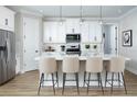 Stylish kitchen featuring a center island with seating, modern appliances, and ample cabinet space at 12574 Somatic Ct, Venice, FL 34293