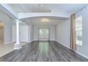 Spacious living room with hardwood flooring, modern fixtures, neutral walls, and lots of natural light at 15126 Shearcrest Dr, Lithia, FL 33547