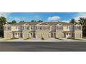 Exterior view of townhomes with garages, shutters, and landscaping under a blue sky at 2486 Riversong Lodge Ln, Wesley Chapel, FL 33543