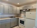 Kitchen featuring neutral cabinets and white appliances at 2501 Harn Blvd # H20, Clearwater, FL 33764