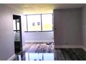 Living room featuring wood floors and a large window for natural light at 2617 Cove Cay Dr # 306, Clearwater, FL 33760