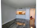 Open-concept living room area with views of a kitchen and wood flooring at 2617 Cove Cay Dr # 306, Clearwater, FL 33760