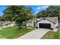Well-maintained home with a spacious driveway and a lush front yard, perfect for outdoor activities at 5092 Abagail Dr, Spring Hill, FL 34608