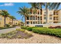 A beautifully landscaped community entrance features lush greenery and upscale luxury townhomes at 6412 Mayra Shores Ln, Apollo Beach, FL 33572