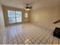 Inviting living room with tile flooring, ceiling fan, and natural light at 6620 121St Ave # 1, Largo, FL 33773