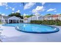 Large community pool with clear blue water, surrounded by a pool deck at 6620 121St Ave # 1, Largo, FL 33773