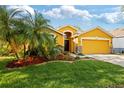 Charming single-Gathering home featuring mature landscaping, well-manicured lawn, and a two car garage at 6914 Monarch Park Dr, Apollo Beach, FL 33572