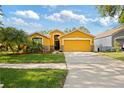 Single-Gathering home with well-maintained lawn, mature trees, two-car garage, and inviting curb appeal at 6914 Monarch Park Dr, Apollo Beach, FL 33572