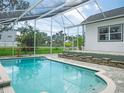 Refreshing screened-in pool area with brick accents, perfect for outdoor relaxation and entertaining at 8759 Orient Ne Way, St Petersburg, FL 33702