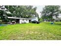 This large backyard has plenty of room for outdoor activities as well as an extra outbuilding for storage at 5623 Southernview Dr, Zephyrhills, FL 33541