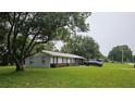 This single story home has a manicured lawn, large shade tree, attached one car garage, and neutral paint at 5623 Southernview Dr, Zephyrhills, FL 33541