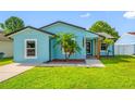 Close up exterior shot of the single-story home with its bright blue exterior at 12351 Cloverstone Dr, Tampa, FL 33624