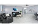 Spacious living room featuring sleek tile flooring, modern furnishings and decor at 12351 Cloverstone Dr, Tampa, FL 33624