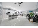 A wide view of the combined kitchen and living spaces and their modern design at 12351 Cloverstone Dr, Tampa, FL 33624