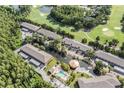 This aerial view showcases the community pool, water features and manicured grounds at 14625 Par Club Cir # 14625, Tampa, FL 33618