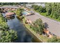 Aerial view of community featuring townhomes, pond, pool, and landscaping at 14625 Par Club Cir # 14625, Tampa, FL 33618