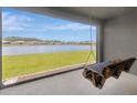 Relaxing covered patio featuring a swing with scenic views of the lake and neighborhood at 18164 Turning Leaf Cir, Land O Lakes, FL 34638