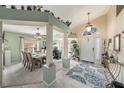 Welcoming foyer featuring high ceilings, elegant columns, and an open layout to the dining area at 371 Quane Ave, Spring Hill, FL 34609