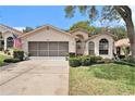 Charming single-story home with a well-manicured lawn, screened garage, and lovely curb appeal at 371 Quane Ave, Spring Hill, FL 34609