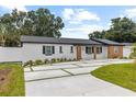 Lovely single-story house featuring new landscaping and a unique concrete driveway design at 3909 W Oklahoma Ave, Tampa, FL 33616