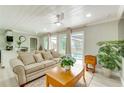 Open living room featuring bright natural light, a ceiling fan, and direct access to the pool at 4362 Wesley Ln, North Port, FL 34287