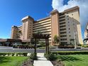 A low-angle view of a luxury condominium complex with lush green landscaping and covered parking at 5108 Brittany S Dr # 405, St Petersburg, FL 33715