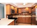 Well-maintained kitchen with stainless steel appliances, wooden cabinetry, and recessed lighting at 5108 Brittany S Dr # 405, St Petersburg, FL 33715