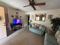 Comfortable living room featuring a ceiling fan, and neutral décor, creating a relaxing atmosphere at 5901 N 34Th St, Tampa, FL 33610