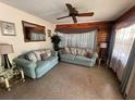Inviting living room with comfortable sofas, a ceiling fan, and natural light from the window at 5901 N 34Th St, Tampa, FL 33610