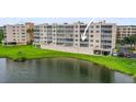 Condo building with parking area overlooking a pond at 6450 Shoreline Dr Dr # 9202, St Petersburg, FL 33708