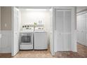 Functional laundry room with modern washer, dryer, and extra storage space at 6450 Shoreline Dr Dr # 9202, St Petersburg, FL 33708