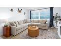 Inviting living room featuring a comfortable sectional, beach view, and stylish decor at 11000 Gulf Blvd # 1002, Treasure Island, FL 33706
