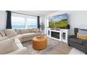 Comfortable living room with large windows boasting stunning beach views at 11000 Gulf Blvd # 1002, Treasure Island, FL 33706