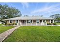 Charming brick home with large front yard, white fence, and brick pathway at 11301 Donneymoor Dr, Riverview, FL 33569