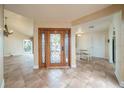 Welcoming foyer with tile flooring, chandelier, and a decorative wood front door with iron accents at 11503 Robles Del Rio Pl, Temple Terrace, FL 33617