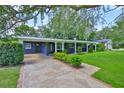 Inviting single-story home with a covered porch and stone pathway at 1708 Pond Lake Dr, Tampa, FL 33612