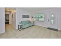Cozy living room with tile flooring, a loveseat, and bright natural light at 1708 Pond Lake Dr, Tampa, FL 33612