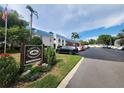 Belleair Oaks Condominiums with parking lot in front of a well maintained two-story building at 1975 W Bay Dr # 304, Largo, FL 33770