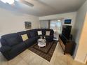 Cozy living room features a comfy sectional, stylish coffee table, and sliding glass doors at 1975 W Bay Dr # 304, Largo, FL 33770