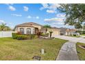 Charming home with lush lawn, manicured garden, and a welcoming walkway, perfect for Gathering living at 22623 Cliffside Way, Land O Lakes, FL 34639