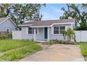 Inviting single-story home featuring a charming blue door and freshly landscaped front yard at 2311 16Th S Ave, St Petersburg, FL 33712