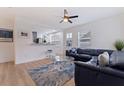 Inviting living room with a blue leather sofa, modern fan, and open floor plan to the kitchen at 2311 16Th S Ave, St Petersburg, FL 33712